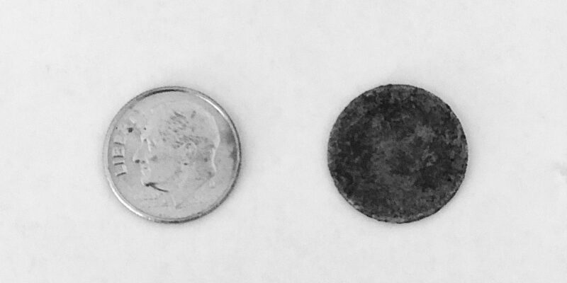 One shiny dime and one dirty dime on white background